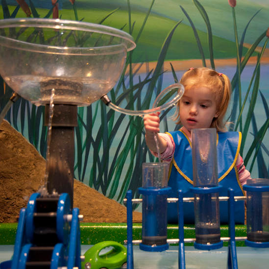 small girl playing with the toddler water table